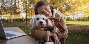 front-view-smiley-woman-holding-dog